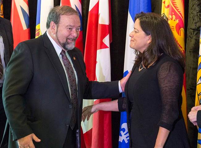 New Brunswick Justice Minister Denis Landry chats with federal Justice Minister Jody Wilson-Raybould at the closing news conference of a meeting of federal, provincial and territorial justice and public safety ministers, in Halifax on Friday, Oct. 14, 2016. 