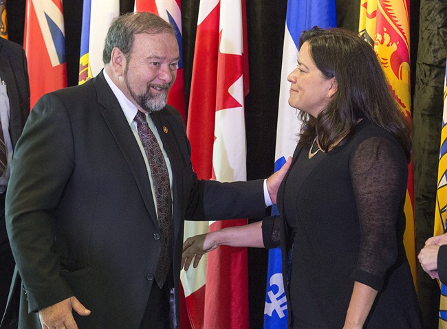 New Brunswick Justice Minister Denis Landry chats with federal Justice Minister Jody Wilson-Raybould at the closing news conference of a meeting of federal, provincial and territorial justice and public safety ministers, in Halifax on Friday, Oct. 14, 2016. 