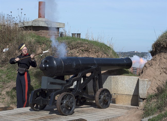 Sgt. Brittany Avery, dressed as the 3rd Brigade Royal Artillery of 1869, fires the noon gun at the Halifax Citadel National Historic Site in Halifax on Friday, Oct. 7, 2016.