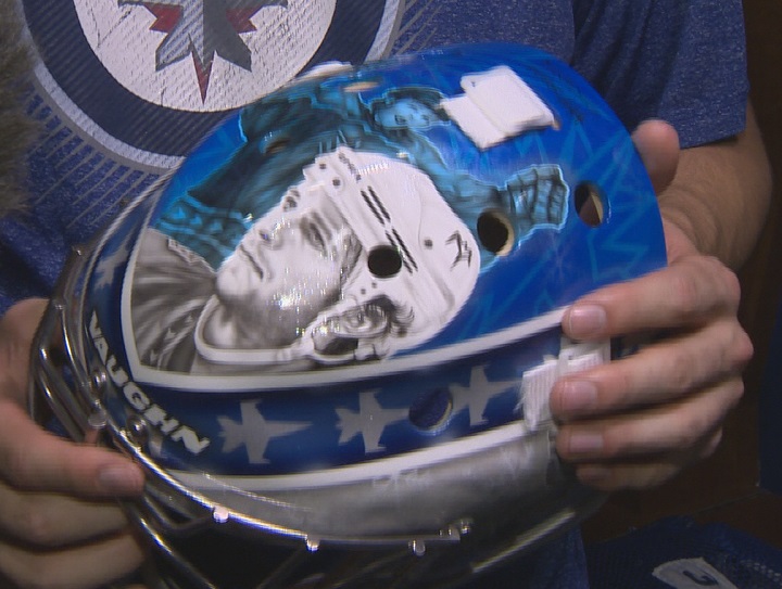 Winnipeg Jets goaltender Connor Hellebuyck shows off his new goalie mask.