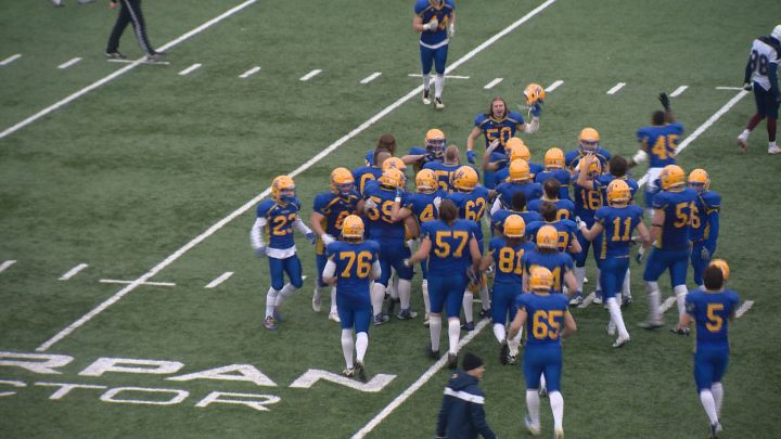 The Saskatoon Hilltops celebrate on the field following their 25-24 win over the Regina in the PFC semifinal.