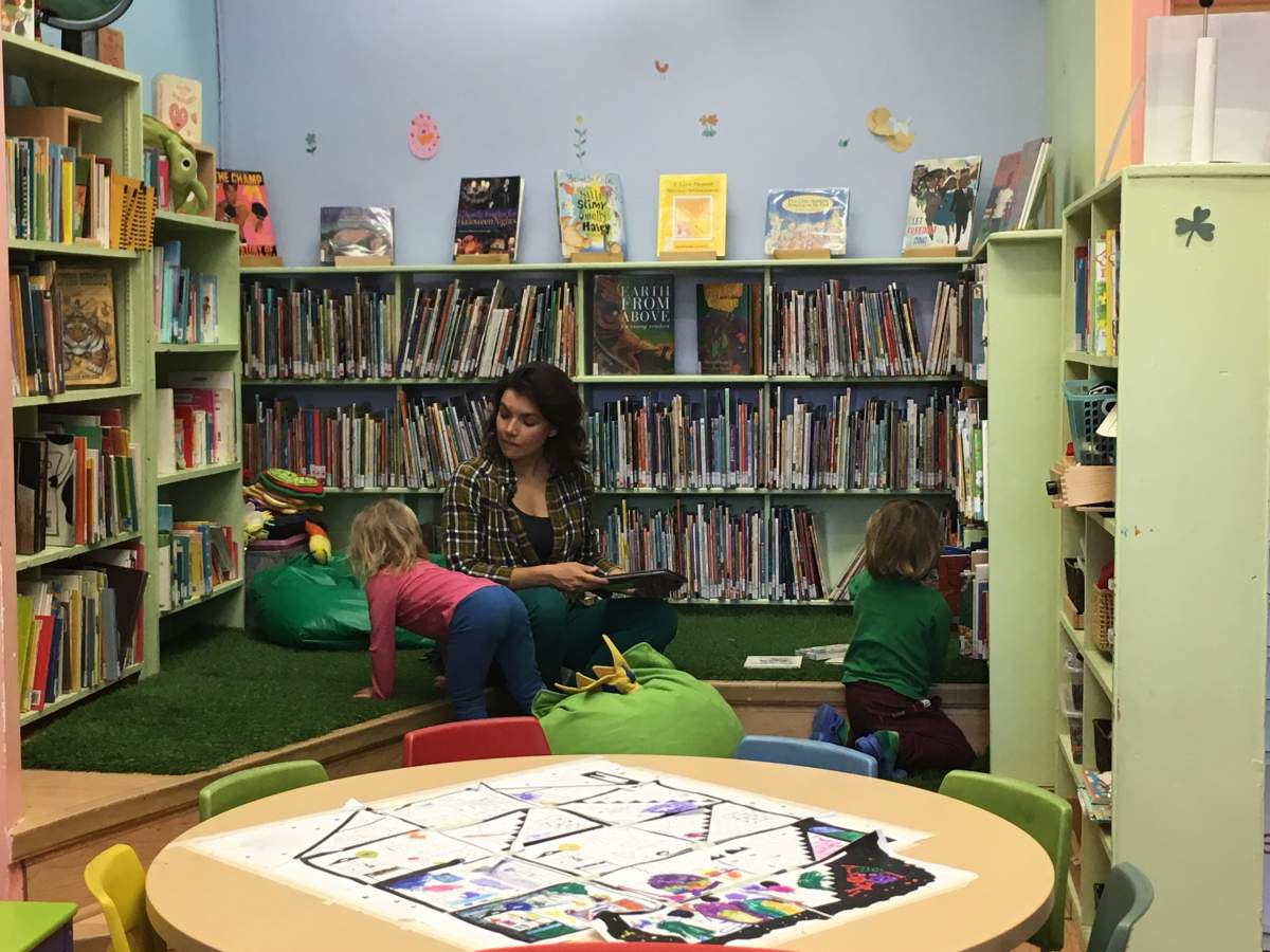 Mother Raquel Romano with her children in the library, Tuesday, October 18, 2016.