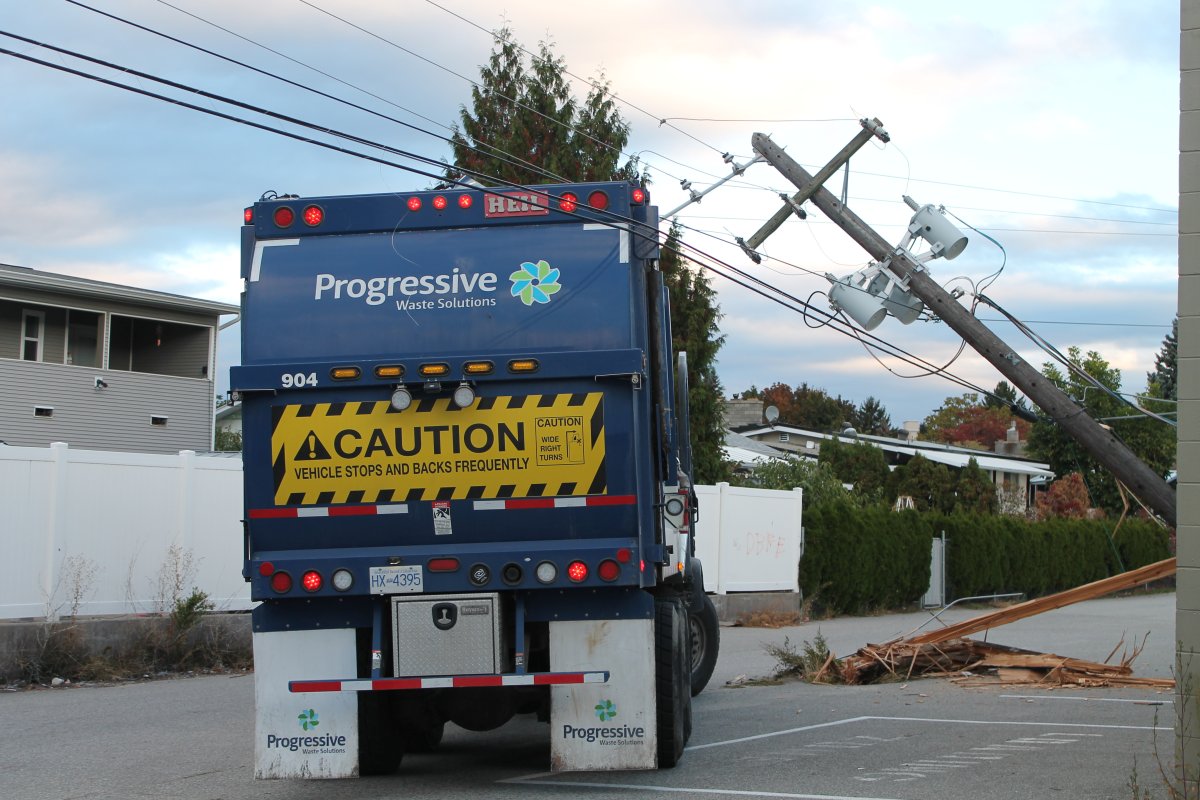Garbage truck hits power pole.