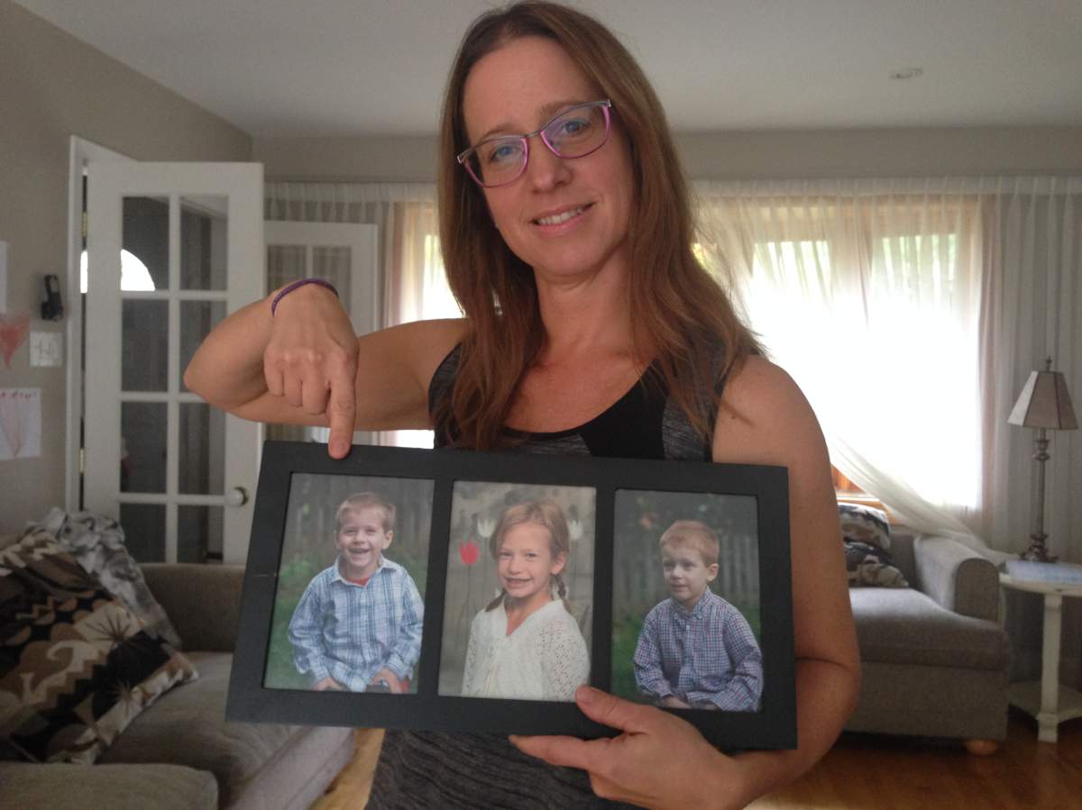 Anna Bisakowski points to a photo of her son, Simon, who lives with autism, Wednesday, October 26, 2016.