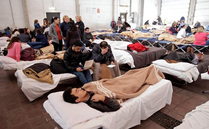 People take a rest after an earthquake in central Italy in a hangar used for recovery in Camerino, Italy October 27, 2016. REUTERS/Max Rossi.