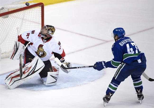 Ottawa Senators goalie Craig Anderson (41) stops a shot from Vancouver Canucks left wing Sven Baertschi (47) during third period NHL action in Vancouver, B.C. Tuesday, Oct. 25, 2016. 