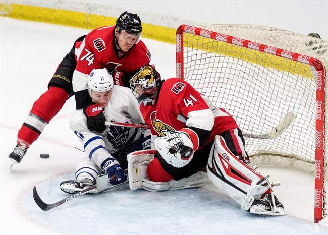 Ottawa Senators goalie Craig Anderson and Ottawa defenceman Mark Borowiecki tie up Toronto Maple Leafs forward Zach Hyman during the third period of an NHL pre-season hockey game in Saskatoon, Tuesday, October 4, 2016.