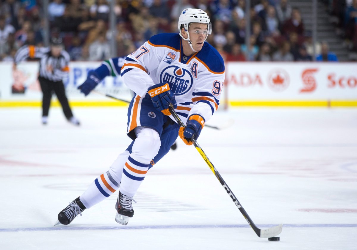Edmonton Oilers' Connor McDavid skates with the puck during the first period of a pre-season NHL hockey game against the Vancouver Canucks in Vancouver, B.C., on Wednesday September 28, 2016. THE CANADIAN PRESS/Darryl Dyck.