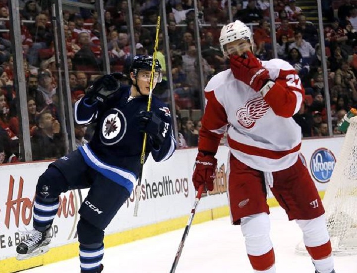 Winnipeg Jets' Marko Dano (left) celebrates his goal during the first period of an NHL hockey game against the Detroit Red Wings on March 10, 2016.