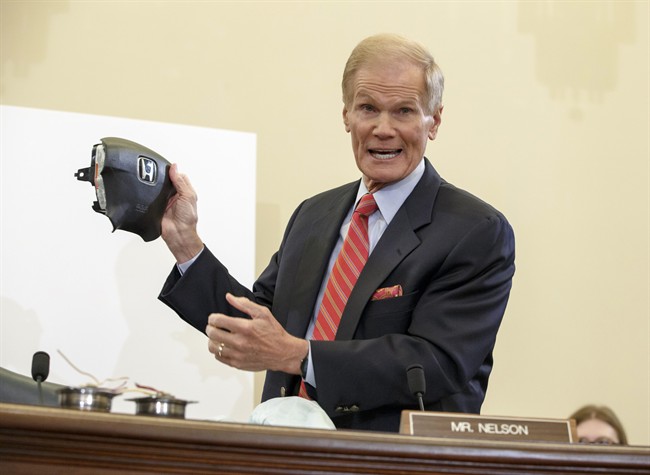 In this Thursday, Nov. 20, 2014, file photo, Senate Commerce Committee member Sen. Bill Nelson, D-Fla., displays the parts and function of a defective airbag made by Takata that has been linked to multiple deaths and injuries in cars driven in the United States. 