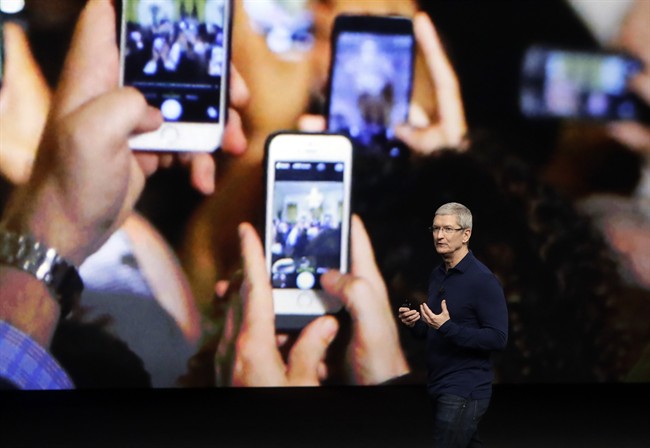 In this Wednesday, Sept. 7, 2016, file photo, Apple CEO Tim Cook announces the new iPhone 7 during an event to announce new products, in San Francisco. Apple reported Tuesday, Oct. 25, 2016, that it sold 45.5 million iPhones in the previous quarter, 5 percent fewer than it sold a year earlier. But the giant tech company's rosy forecast for the holidays was better than what Wall Street had been expecting. (AP Photo/Marcio Jose Sanchez, File).
