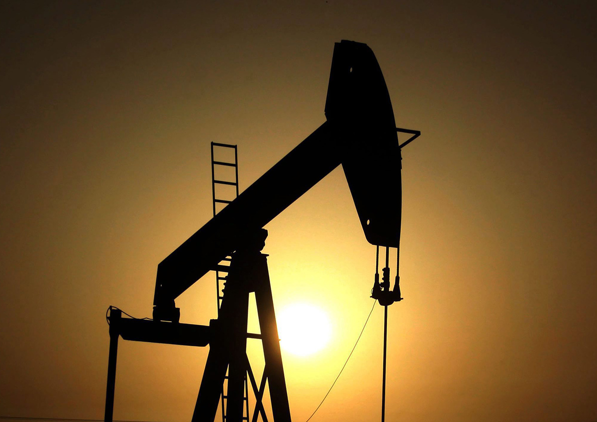 In this Wednesday, June 8, 2011 file photo, sun sets behind an oil pump in the desert oil fields of Sakhir, Bahrain. 