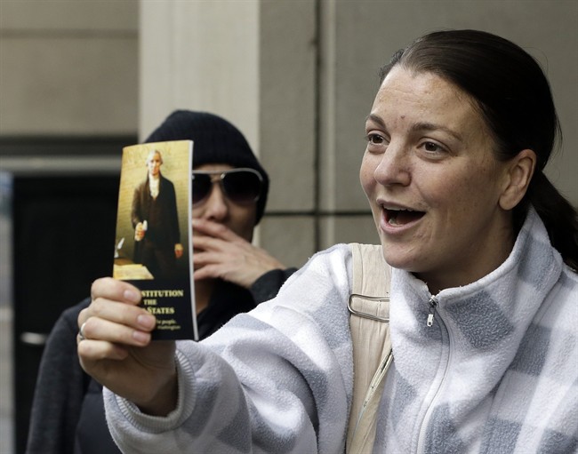 A supporter holds out a copy of the constitution after hearing a verdict outside federal court in Portland, Ore., Thursday, Oct. 27, 2016. A jury exonerated brothers Ammon and Ryan Bundy and five others of conspiring to impede federal workers from their jobs at the Malheur National Wildlife Refuge. 