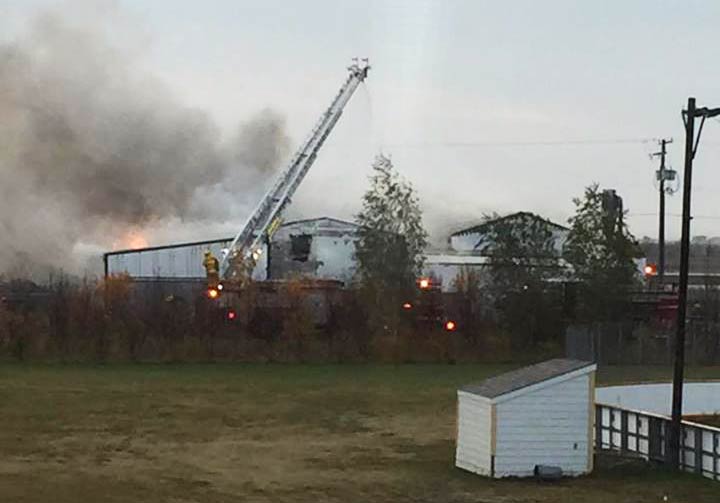 Fire crews work to extinguish a blaze at a Osler, Sask., business on Sunday.