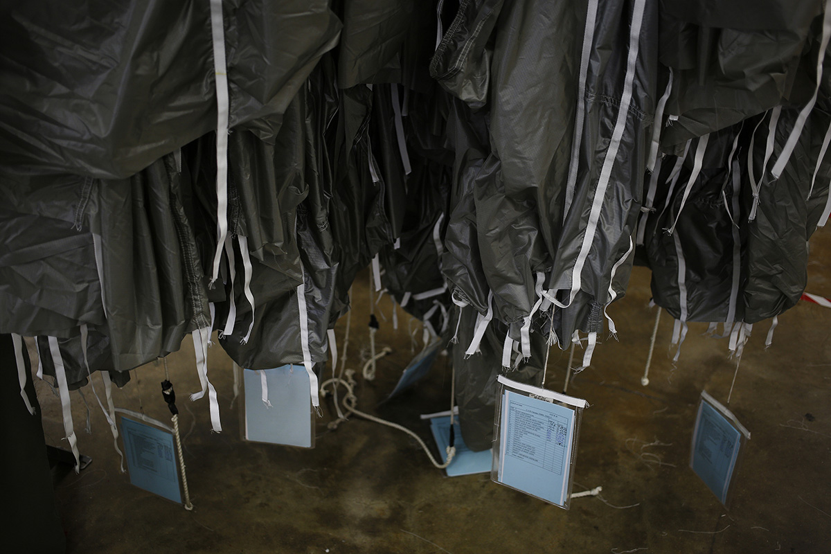 Parachute canopies hanging down in a factory. Vlad Lucas was killed when his parachute failed to open. 