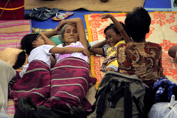 Evacuees from coastal villages take shelter inside an evacuation centre as Typhoon Haima (locally named Lawin) approaches, in Alcala town, Cagayan province, north of Manila.