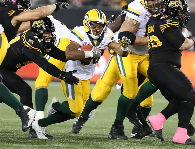 Edmonton Eskimos running back John White (30) runs for some yards during the second-half of CFL football action against the Hamilton Tiger-Cats in Hamilton on Friday, October 28, 2016. 