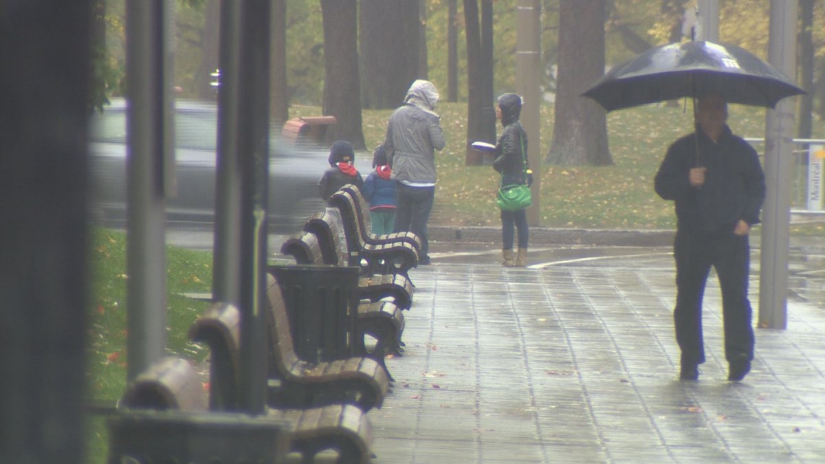 Pedestrians stand in the rain in Montreal.