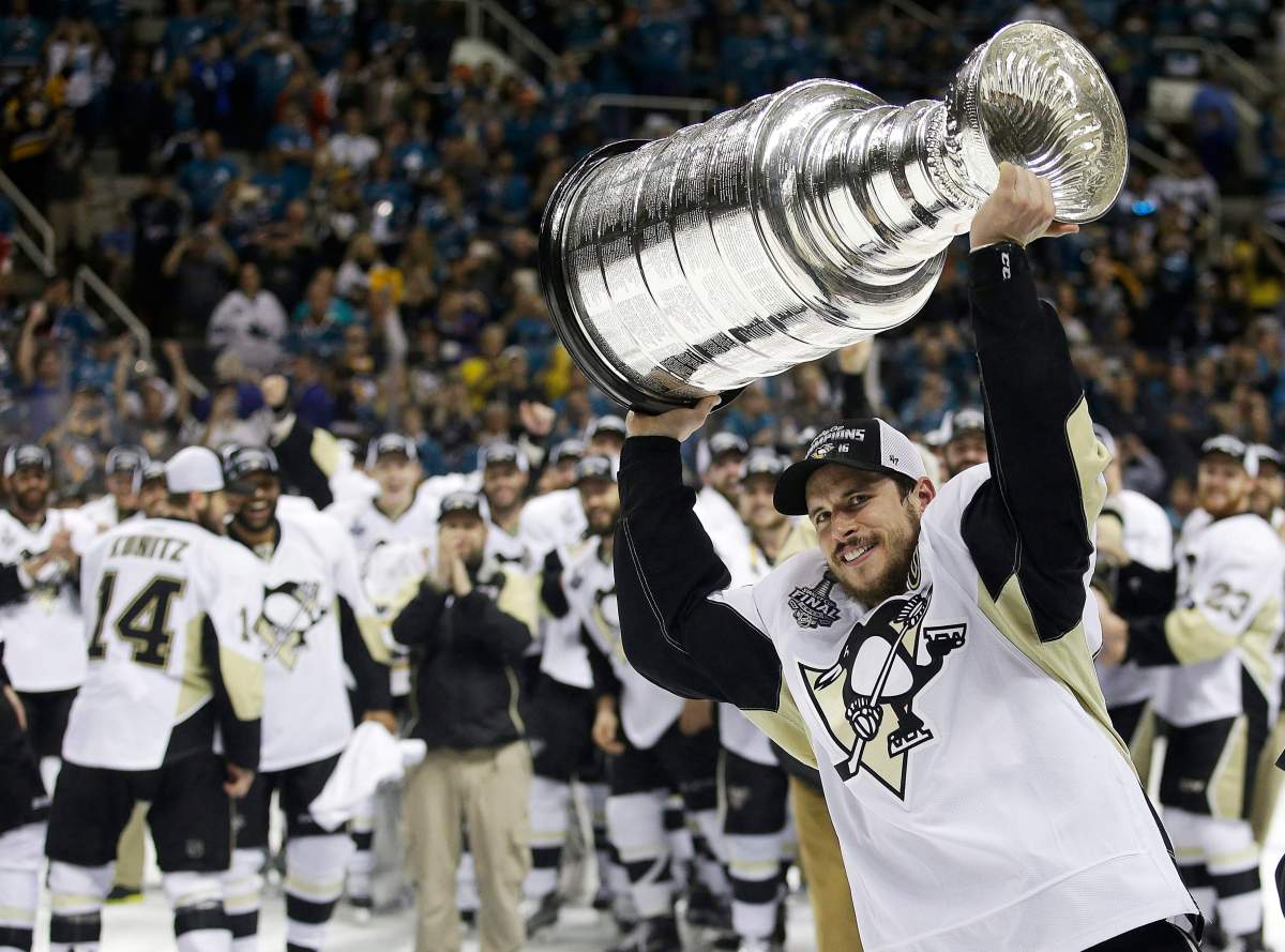 FILE – In this June 12, 2016, file photo, Pittsburgh Penguins center Sidney Crosby raises the Stanley Cup after Game 6 of the NHL hockey Stanley Cup Finals against the San Jose Sharks in San Jose, Calif.