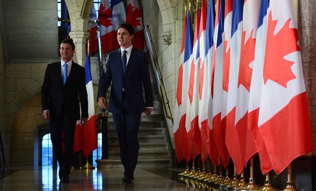 Canadian Prime Minister Justin Trudeau and French Prime Minister Manuel Valls walk to a joint media availability on Parliament Hill in Ottawa, Thursday October 13, 2016.