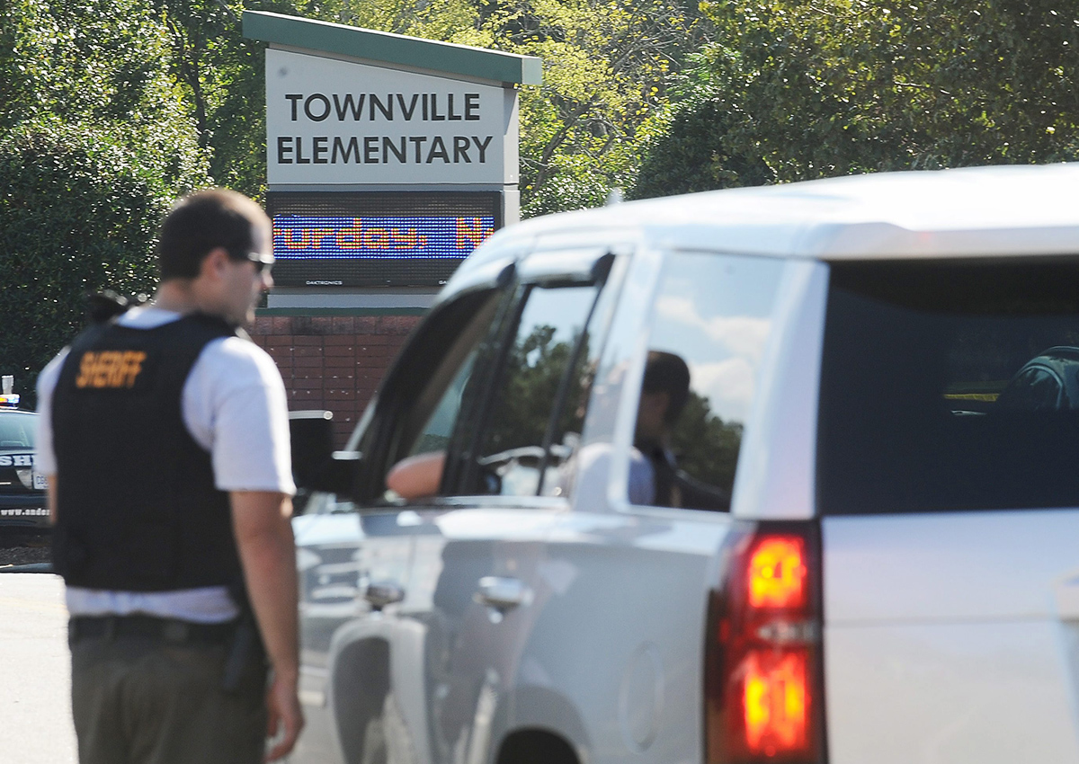 Members of law enforcement talk in front of Townville Elementary School on Wednesday, Sept. 28, 2016, in Townville, S.C.  