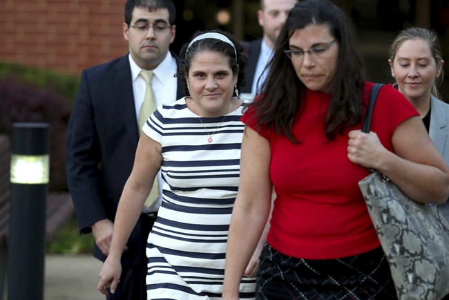 Nicole Eramo, center, leaves the federal courthouse, Wednesday, Oct. 19, 2016 in Charlottesville, Va.. Eramo, a University of Virginia administrator who sued Rolling Stone magazine over its portrayal of her in a now-discredited story about a gang rape said Wednesday that the magazine's apologies for its journalistic failures didn't go far enough. (Ryan M. Kelly/The Daily Progress via AP).