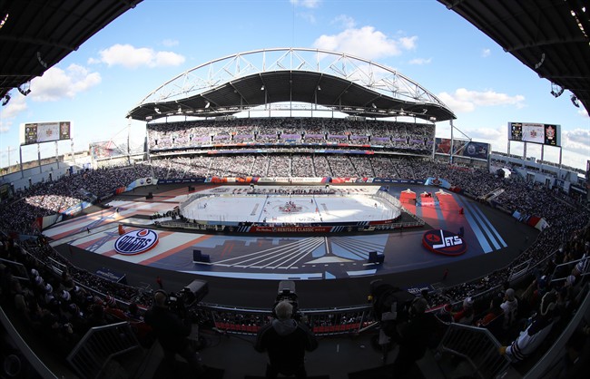 Opening face off between the Winnipeg Jets and Edmonton Oilers at the 2016 NHL Heritage Classic at Investors Group Field in Winnipeg on Sunday.