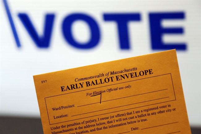 In this Oct. 24, 2016, photo, an early ballot envelope is held at town hall in North Andover, Mass. The millions of votes that have been cast already in the U.S. presidential election point to an advantage for Hillary Clinton in critical battleground states, as well as signs of strength in traditionally Republican territory. (AP Photo/Elise Amendola).