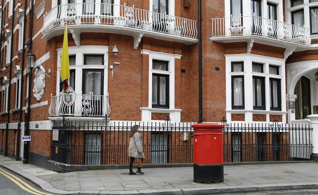 A woman walks past the Ecuadorian Embassy in London, Tuesday, Oct. 18, 2016. Midway through releasing a series of damaging disclosures about U.S. presidential contender Hillary Clinton, WikiLeaks founder Julian Assange says his hosts at the Ecuadorean Embassy in London abruptly cut him off from the internet. The news adds another layer of intrigue to an extraordinary campaign. (AP Photo/Alastair Grant).