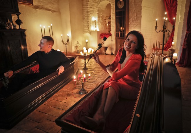 Events manager Tami Varma and her brother Robin, a PhD student, the grandchildren of Devendra Varma, a scholar of English gothic tales and an expert in vampire lore, pose in coffins at Bran Castle, in Bran, Romania, Monday, Oct. 31, 2016. A Canadian brother and sister are passing Halloween night curled up in red velvet coffins in the Transylvanian castle that inspired the Dracula legend, the first time in 70 years anyone has spent the night in the gothic fortress after they bested 88,000 people who entered a competition hosted by Airbnb to get the chance to dine and sleep at the castle in Romania. 
