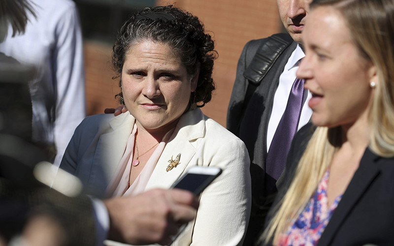 University of Virginia administrator Nicole Eramo, left, listens to attorney Libby Locke, right, speak with the media outside the federal courthouse in Charlottesville, Va., on Friday, Nov. 4, 2016. 