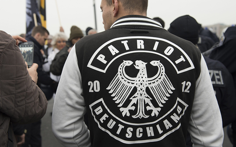 A demonstrator wears a jacket with the writing "Patriot Deutschland" (lt. Germany Patriot) during the fourth demonstration of the right-wing populist alliance 'Wir fuer Deutschland' in Berlin, Germany, Saturday,  Nov. 5, 2016. 