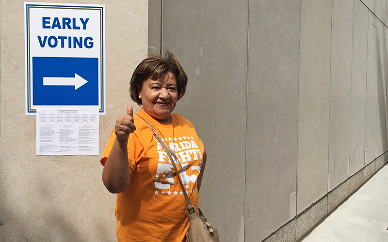 Nancy Osores leaves an early voting booth in Miami on Oct. 24, 2016. 