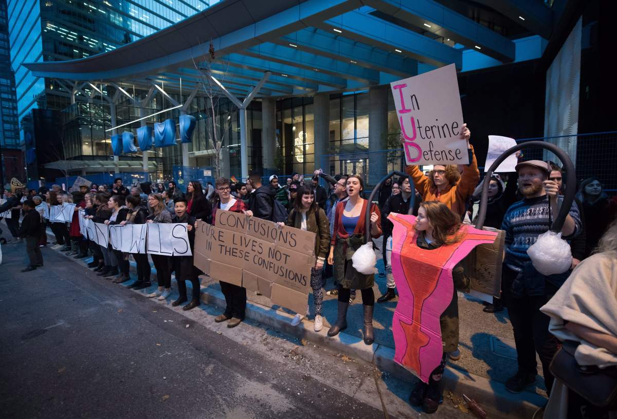 Protesters hold a rally against U.S. President-elect Donald Trump outside the still under construction Trump Hotel, in Vancouver, B.C., on Thursday November 10, 2016. THE CANADIAN PRESS/Darryl Dyck.