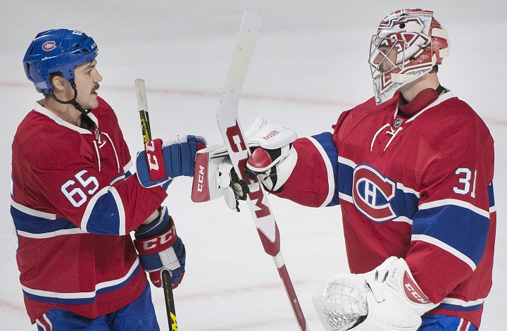 Montreal Canadiens goaltender Carey Price celebrates with teammate Andrew Shaw, left, after defeating the Detroit Red Wings in an NHL hockey game in Montreal, Saturday, November 12, 2016. THE CANADIAN PRESS/Graham Hughes