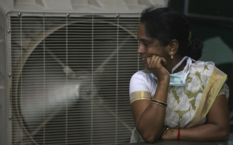 A woman cools herself on a hot summer day in Hyderabad, in the southern Indian state of Telangana. 