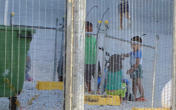 An undated supplied image from Amnesty International claiming to show children playing near a fence at the country's Australian-run detention centre on the Pacific island nation of Nauru.