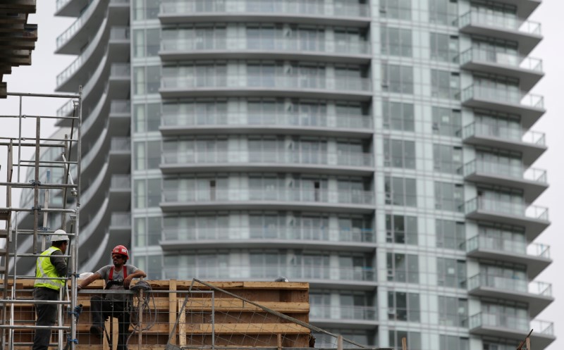 Construction workers chat on a condominium building site in Toronto, Ontario, Canada October 3, 2016. 