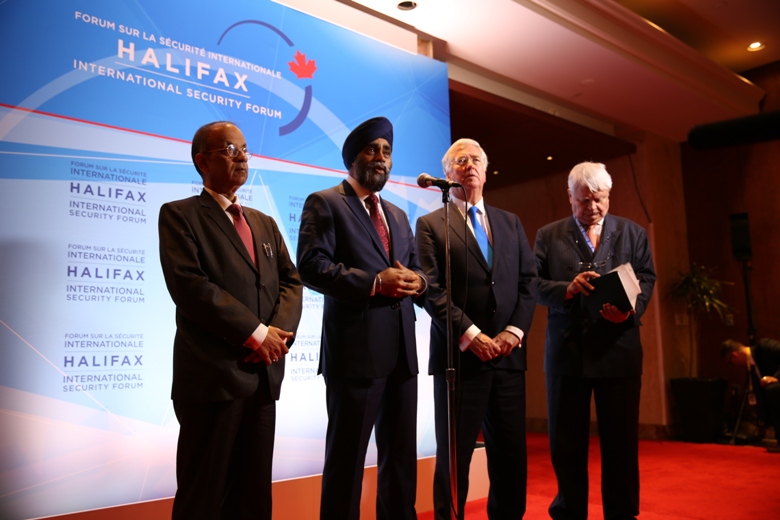 Defence Minister Harjit Sajjan addresses reporters in Halifax alongside British Secretary of State for Defence Michael Fallon, UN undersecretary general for peacekeeping operations Hervé Ladsous (R), and Atul Khare, the UN's undersecretary general for field support (L).