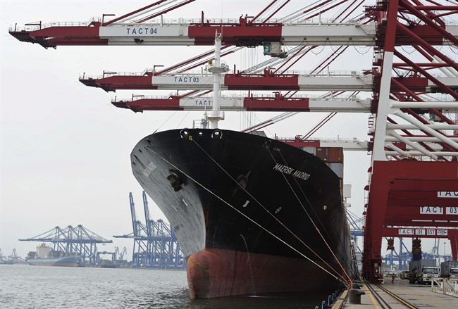 Containers are loaded onto a cargo ship at the Tianjin port in China in this Aug. 5, 2010 file photo.
