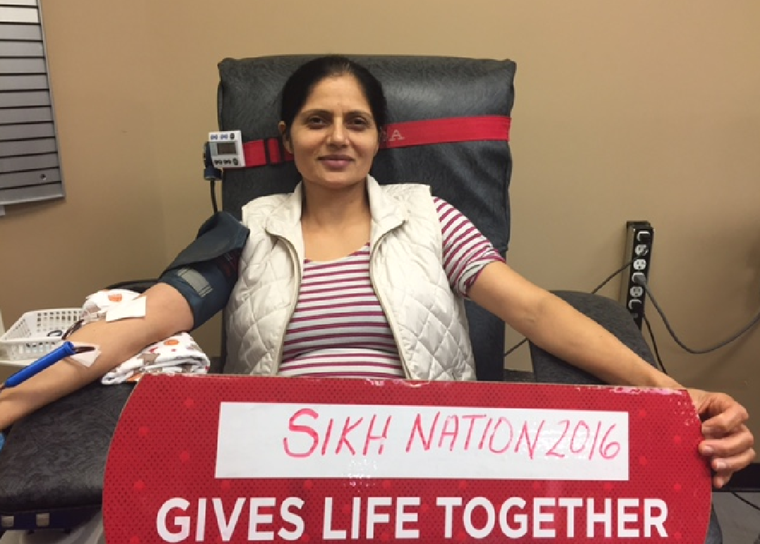 A woman donates blood at the Sikh Nation blood drive in Kelowna on Saturday.