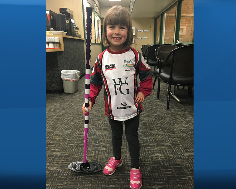 Camryn showing off her mini Team Jones jersey at her mom's curling practice. 