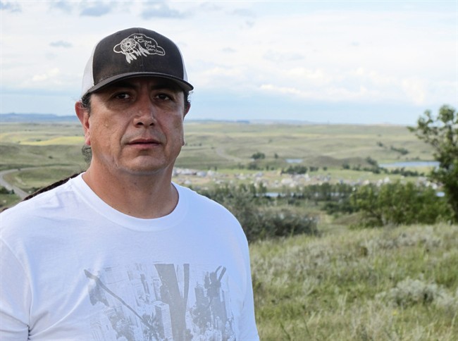 FILE – In this Aug. 26, 2016 file photo, Standing Rock Sioux Chairman Dave Archambault II poses for a photo near Cannon Ball., N.D., on the Standing Rock Sioux Reservation overlooking an encampment where Native Americans are gathered to join his tribe’s growing protest against the Dakota Access oil pipeline.