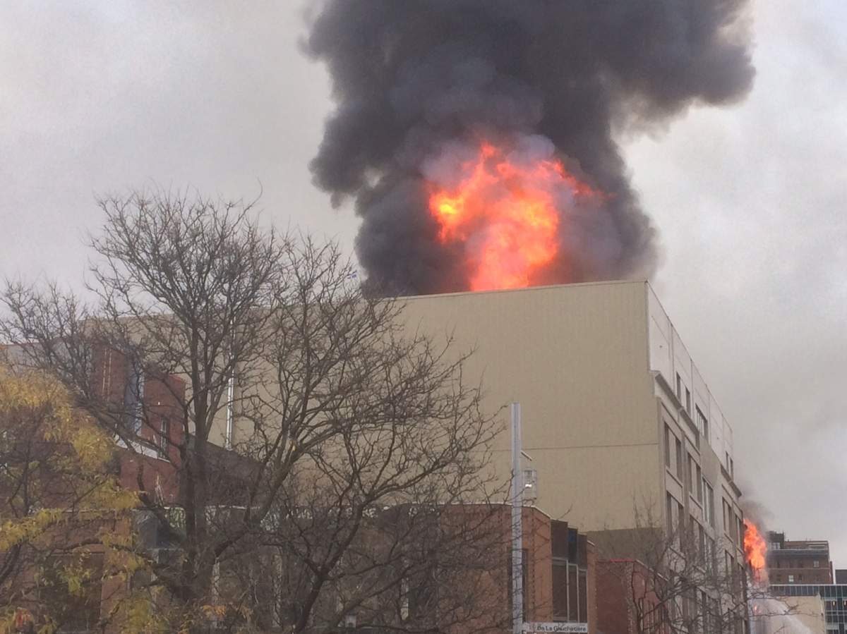A fire rages in a building in Montreal's Chinatown, Thursday, November 17, 2016.