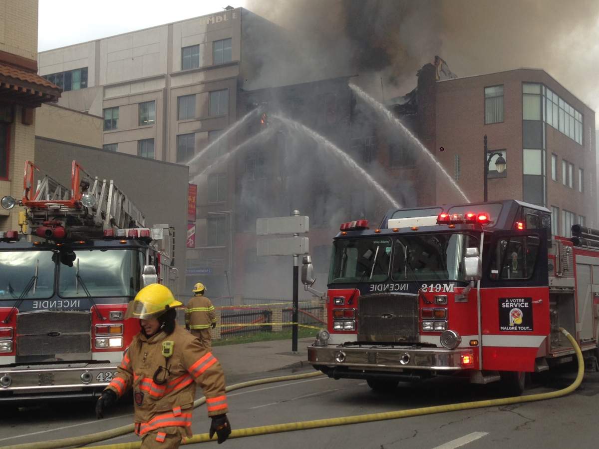 Firefighters battle a blaze in a building in Montreal's Chinatown, Thursday, November 17, 2016.