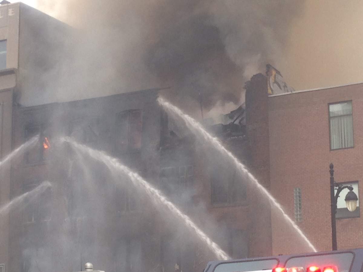Firefighters battle a blaze in a building in Montreal's Chinatown, Thursday, November 17, 2016.