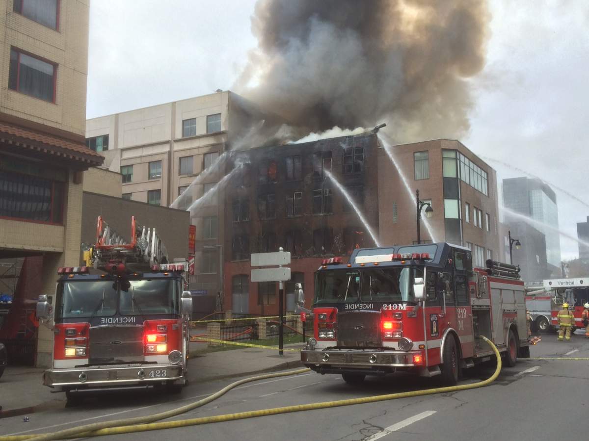 Firefighters battle a blaze in a building in Montreal's Chinatown, Thursday, November 17, 2016.