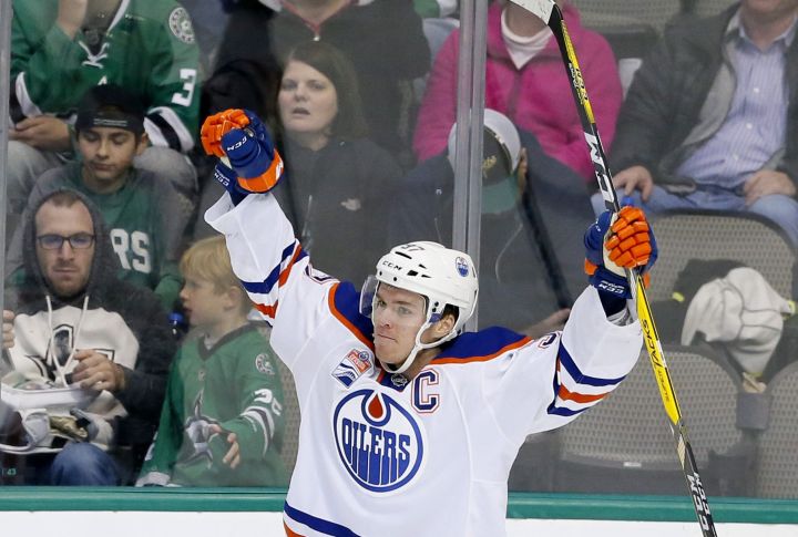 Edmonton Oilers center Connor McDavid (97) celebrates scoring against the Dallas Stars in the third period of an NHL hockey game, Saturday, Nov. 19, 2016, in Dallas. The score was McDavid's third of the game. 