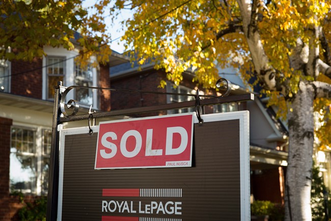 A real estate sold sign hangs in front of a west-end Toronto property Friday, Nov. 4, 2016. THE CANADIAN PRESS/Graeme Roy.