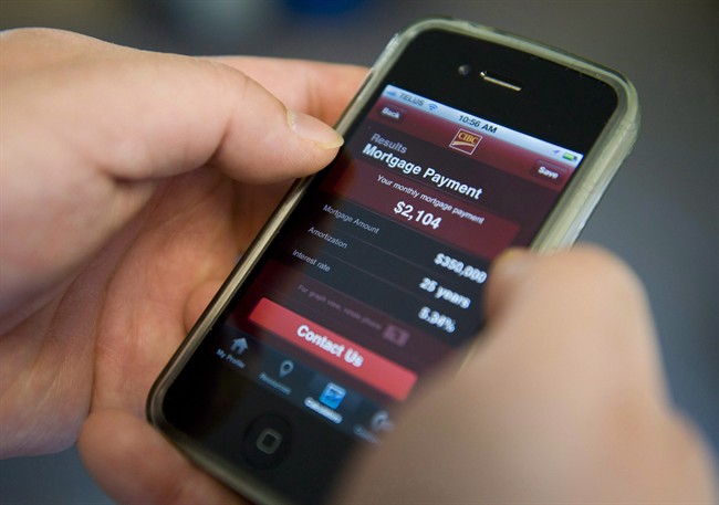 A smart phone user checks their bank account with an online banking app from CIBC in Ottawa on Friday, April 1, 2011. 